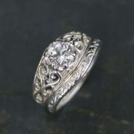 Silver Bridal Set Silver Engagement Ring Filigree Sleeping Beauty Moissanite Ring Sleeping Beauty Ring Filigree Hearts Sweetheart Ring"I know you. I've walked with you once upon a dream." ~ Princess Aurora, Sleeping BeautyWe all know that song! Predestined love; finding each other. This stunning antique style setting features filigree vines twining up each side of the shank. It measures 8.5mm at the widest point, tapering to 2.95mm in the back. The 6mm genuine faceted clear stone of your choice Wedding Heart Ring With Rose Cut Diamonds, Rose Cut Diamond Heart Wedding Ring, Wedding Heart Cut Ring With Rose Cut Diamonds, Fine Jewelry Moissanite Heart Ring For Wedding, Fine Jewelry Wedding Heart Ring In Moissanite, Fine Jewelry Heart Ring In Moissanite For Wedding, Fine Jewelry Heart Ring With Moissanite For Wedding, Moissanite Heart Ring For Wedding With Round Cut, White Gold Moissanite Heart Ring For Wedding