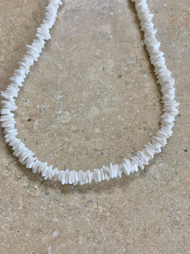 Puca Shell Necklace. White Natural Puca shells from Hawaii. Hand strung on stainless steel wire. Necklace measures 21" in length. Can request length needed in ordering. Prices vary according to length. Adjustable White Shell Necklace Gift, Adjustable White Shell Necklace For Gift, Adjustable White Shell Jewelry, Adjustable Strand Necklace With Lobster Clasp, Adjustable Shell Necklace With Lobster Clasp For Gift, White Round Beads Shell Necklace Gift, White Round Beads Shell Necklace As Gift, White Shell Necklace With Round Beads For Gift, Adjustable Single Strand White Jewelry