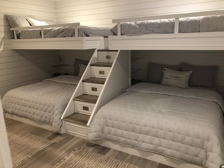 two bunk beds with stairs leading up to them