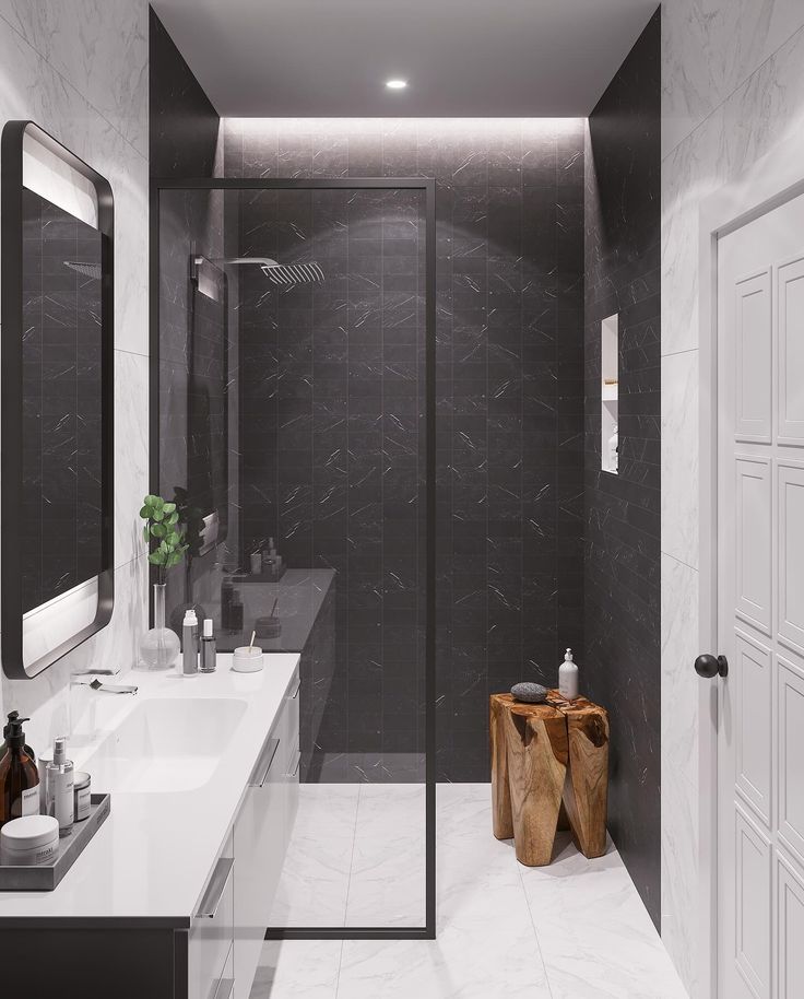 a bathroom with black and white walls, marble flooring and large mirror on the wall