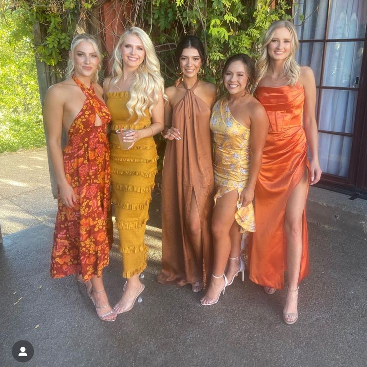 four beautiful women standing next to each other