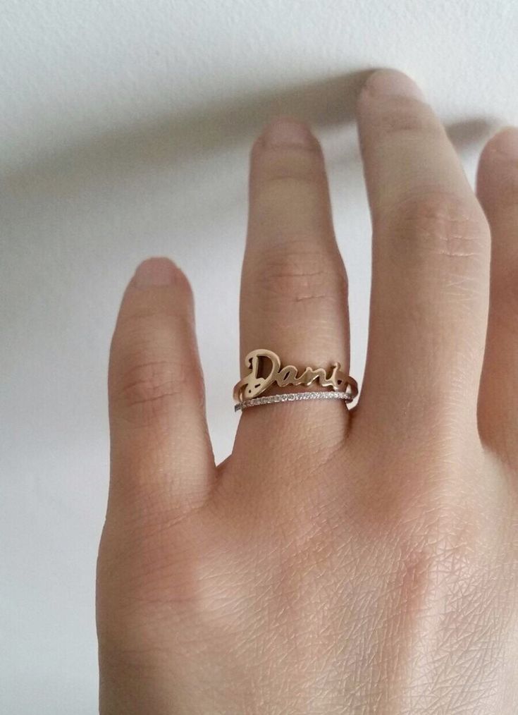 // FREE SHIPPING within U.S. // This 14k solid gold Skinny Name Ring is simply elegant. Gracefully wrap your or your loved ones name around your finger. Available in 14k yellow, white or rose gold. Makes a beautiful modern wedding ring; its simplicity also makes a lovely anniversary ring or push present for stacking with other rings. DETAILS: - First letter measures approximately 7mm - Lowercase letters measure approximately 3.5mm - Bottom shank measures 1.25mm Please write the name of your choi Promise Ring With Custom Nameplate, Elegant 14k Gold Jewelry With Names, Custom Name Plate Ring For Promise, Customizable Rose Gold Promise Rings, Custom Name White Gold Jewelry For Promise, Personalized Yellow Gold Wedding Jewelry, 14k Gold Custom Name Engraved Ring For Promise, 14k Gold Engraved Ring With Custom Name For Promise, Customizable 14k Gold Jewelry For Promise