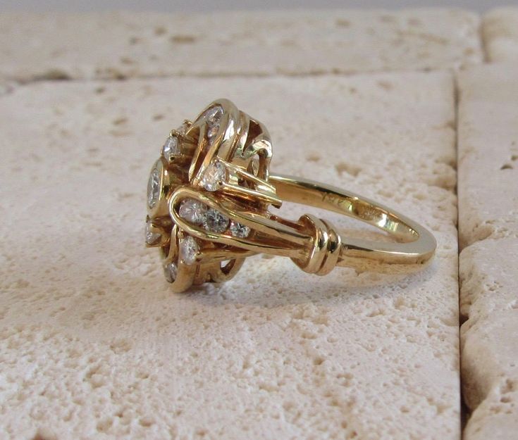 "18 karat yellow gold diamond tremblant ring. \"En Tremblant\" jewelry was popular in the 19th century and brought back to life with this ring created in the early to mid 1990's. The three center diamonds are mounted on a spring and trembles as the wearer moves. The ring contains 23 full cut round brilliant diamonds having a combined estimated weight of approximately 1.25 carats. The ring is of sturdy construction. Ring Size: 5-1/4 can be sized Circa: Mid-Late 1990's All rings come with one free Dinner Ring, Diamond Cocktail Ring, Gold Cocktail Ring, Beef Casserole, Dope Jewelry, Ring Shapes, Diamond Cocktail Rings, Enamel Ring, Back To Life