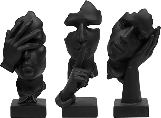 three black sculptures with one holding the other's head