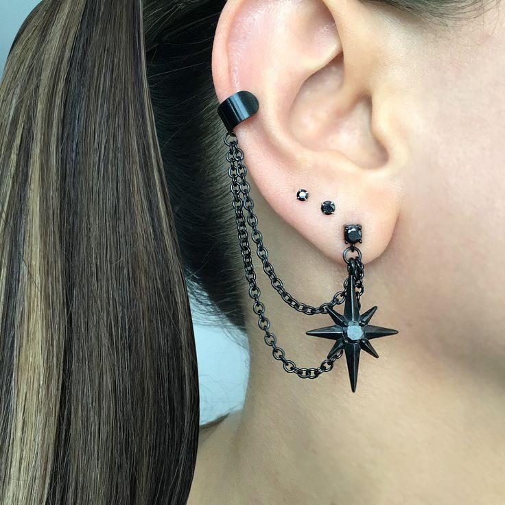 Eye catching and edgy Starburst earrings and cuff  are made of 316L Stainless steel .  Can be purchased as single or a pair. Star earrings -1 1/4 inches long Cuff is 6mm wide Short chain 1 3/4 inches MATCHING STUD IS AVAILABLE HERE: https://www.etsy.com/listing/1505099493/north-star-earring-starburst-earrings?click_key=7109df00438434e9749a84d627c791cbb97fe926%3A1505099493&click_sum=1ba011e1&ga_search_query=star&ref=shop_items_search_2&pro=1&sts=1 Goth Ear Piercings Grunge Jewelry, Ear Piercings Gothic, Different Star Designs, Arrow Ear Piercing, Black Star Earrings, Gothic Ear Piercings, Alternative Ear Piercings, Black Dangle Metal Piercings, Black Metal Dangle Piercings