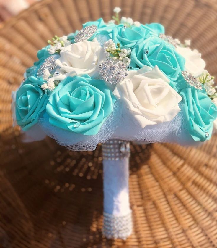 a bridal bouquet with blue and white flowers on a wicker tablecloth background