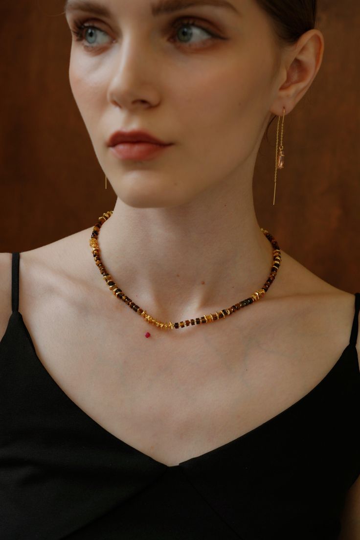 Introducing our exquisite handcrafted necklace, adorned with meticulously beaded Tiger's Eye stones and accented with the timeless elegance of 18k gold. Each Tiger's Eye, known for its rich hues and chatoyant brilliance, is carefully hand-beaded to create a stunning composition. The warm golden tones of the 18k gold enhance the natural beauty of the stones, adding a touch of luxury to this unique piece. Luxury Necklaces With Faceted Beads For Jewelry Making, Elegant Custom Necklace With Gemstone Beads, Elegant Single Strand Round Beads, Elegant Gold Beaded Necklaces For Gifts, Elegant Custom Gemstone Beads Necklace As Gift, Elegant Custom Necklace With Gemstone Beads For Gift, Elegant Polished Yellow Gold Beads, Elegant Yellow Gold Polished Beads, Luxury Beaded Necklace With Polished Rondelle Beads