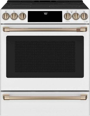 a white oven with gold trimmings on the front and bottom, and an oven door