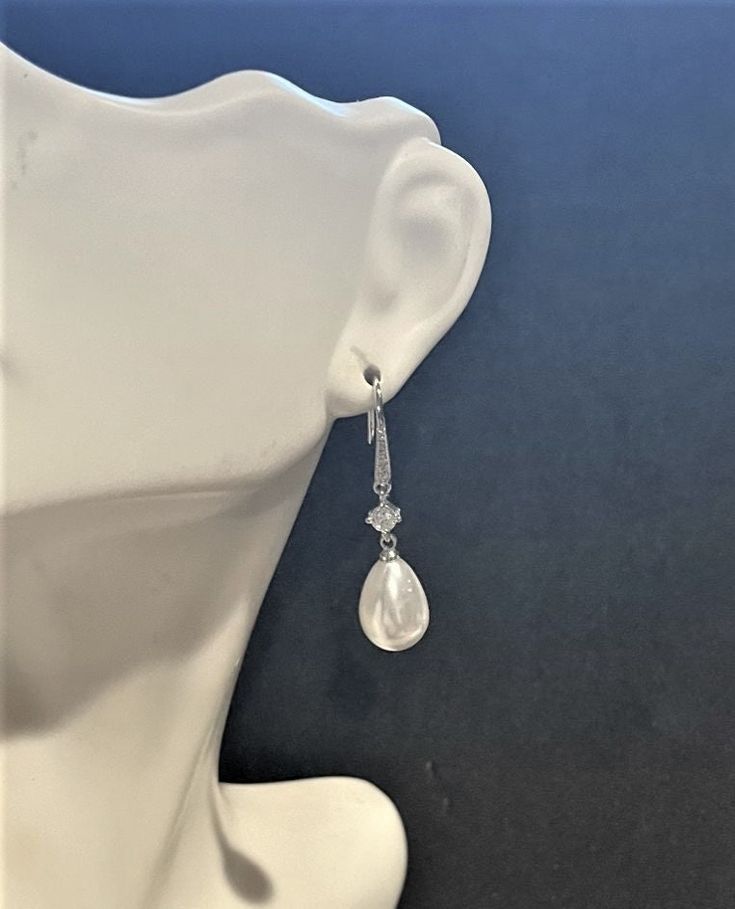 Bridal Faux Pearl Drop Earrings , CZ , Silver ,  Weddings , Engagements  1 1/4 " , Pearl & Crystal Drop Earring 1 1/4 "  Long ...These Beautiful Earrings are Elegant and Simple.... Please ask any questions as I do not accept returns! Thank You Classic Teardrop Linear Earrings For Wedding, Formal Teardrop Pierced Bridal Earrings, Formal Teardrop Bridal Earrings Pierced, Sterling Silver Crystal Pearl Drop Earrings For Wedding, Wedding Sterling Silver Crystal Earrings With Pearl Drop, Formal Teardrop Bridal Earrings, Evening Drop Shape Clip-on Jewelry, Clip-on Drop Jewelry For Evening, Formal Pear-shaped Chandelier Earrings