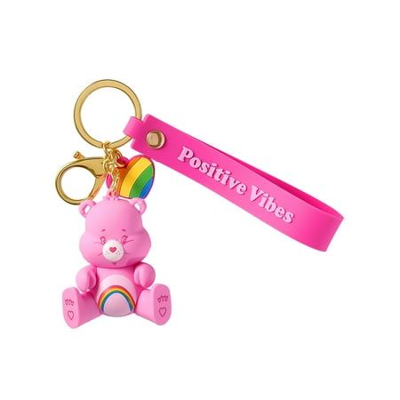 a pink teddy bear keychain with a rainbow heart on it's back