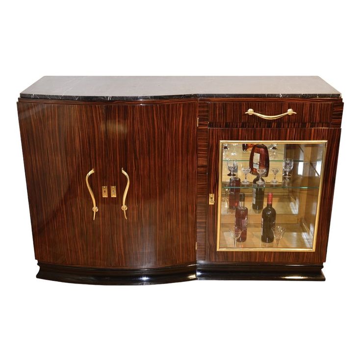 an art deco cabinet with glass doors and handles