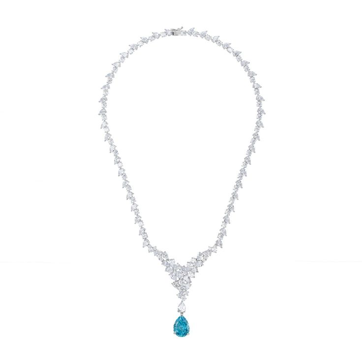 Enhance your elegance with the Lydia Statement Necklace in Blue Topaz Silver. This exquisite piece is designed to mesmerize with its luxurious sparkle. Adorned from end to end with simulated diamonds, it culminates in a fixed triangular arrangement at the front, creating a dazzling focal point. Suspended from the tip of this glittering triangle is a lab-grown teardrop shaped Blue Topaz gemstone, the birthstone for December, adding a sophisticated pop of colour and significance. This versatile pi Blue Diamond Necklace For Formal Occasions, Luxury Blue Diamond Necklace For Formal Occasions, Luxury Light Blue Necklace For Formal Occasions, Formal Light Blue Diamond Necklace, Light Blue Fine Jewelry Necklace For Formal Events, Light Blue Fine Jewelry Necklace For Formal Occasions, Elegant Blue Teardrop Necklace, Formal Blue Necklace With Elegant Design, Elegant Blue Drop Necklaces