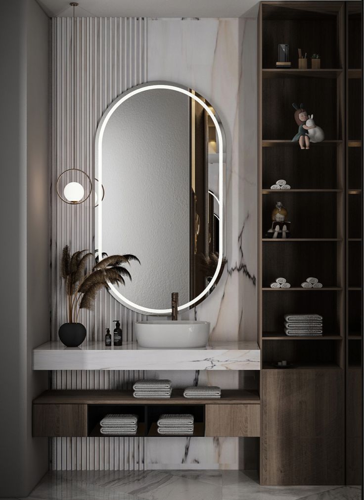 a bathroom with a large round mirror on the wall and a white sink in front of it