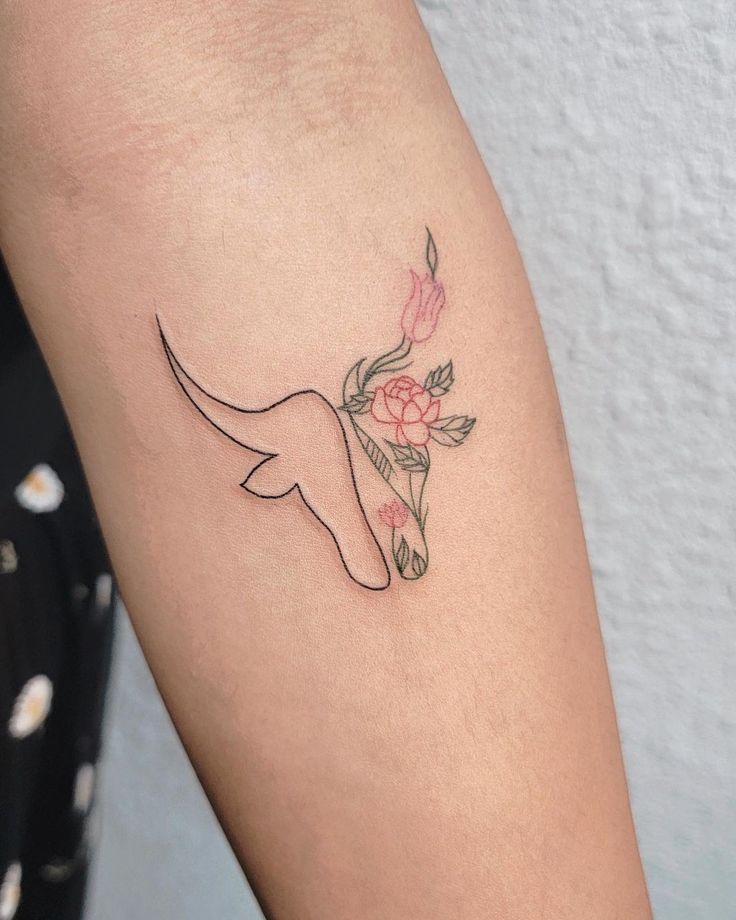 a woman's arm with a flower tattoo on the left side of her body