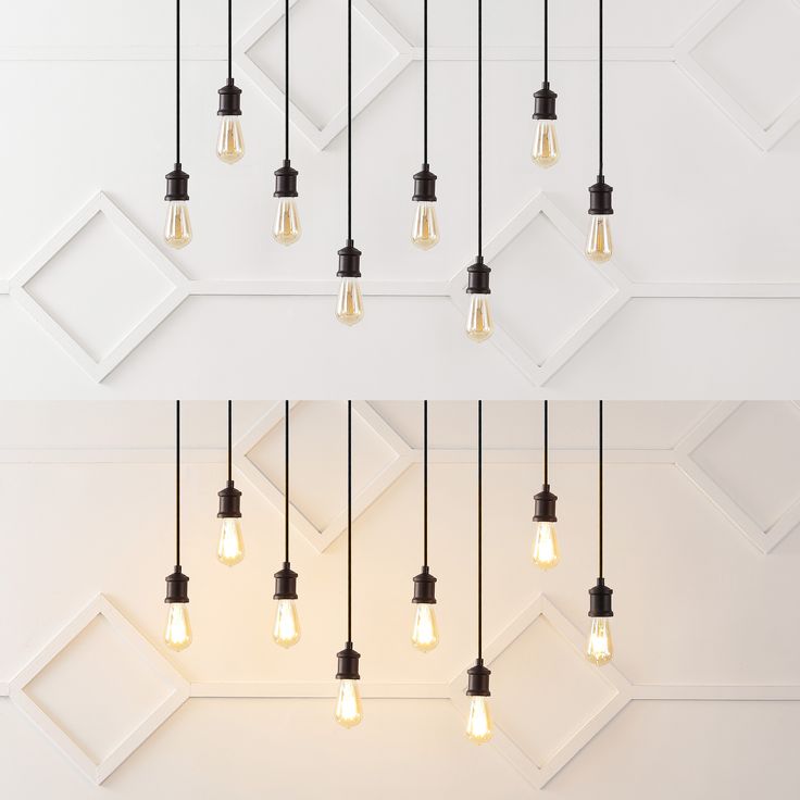 several light bulbs hanging from the ceiling in different styles and sizes, with one being turned on