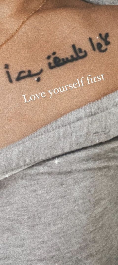 the back of a woman's arm with arabic writing on it and an i love yourself first tattoo