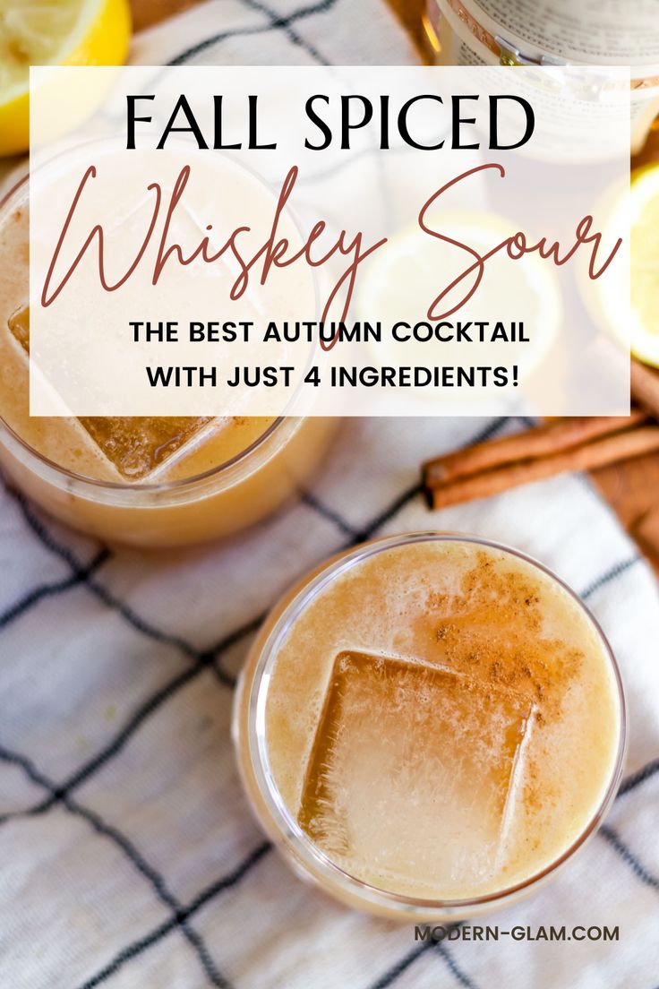 two glasses filled with fall spiced whiskey sour on top of a white table cloth