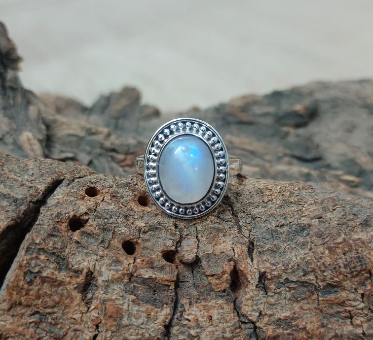 Genuine Moonstone Ring, Moonstone Silver Ring, Moonstone Ring, Moon stone Ring, Boho Ring, Rainbow Moonstone Ring, Gift For Her Product Details  Product - Ring Metal - Sterling Silver Gemstone - Rainbow Moonstone Gemstone Size - 10x12 mm Quality - AAA Handmade Properties :- Moonstone is a very personal stone. It is a reflection of the person who owns it. It does not add or detract, only shows how it is. This is why the moonstone is said to perceive that which "is". Moonstone is an excellent stone to use in meditation to understand oneself. Placing it in the moonlight of a moon reaching its fullness, not a full or waning moon, can revitalize it. This is a particularly good gemstone for women. It is a good stone for young women or teenagers. Healing properties of Moonstone Moonstone is used Bohemian Moonstone Crystal Ring In Moon Shape, Bohemian Moonstone Moon-shaped Crystal Ring, Adjustable Moonstone Ring With Round Stone, Spiritual Round Moonstone Ring, Adjustable Fit Moonstone Ring With Round Stone, Bohemian Moonstone Cabochon Ring, Moonstone Crystal Ring With Moon Phase, Spiritual Moonstone Cabochon Ring, Moon Shaped Moonstone Ring With Natural Stones