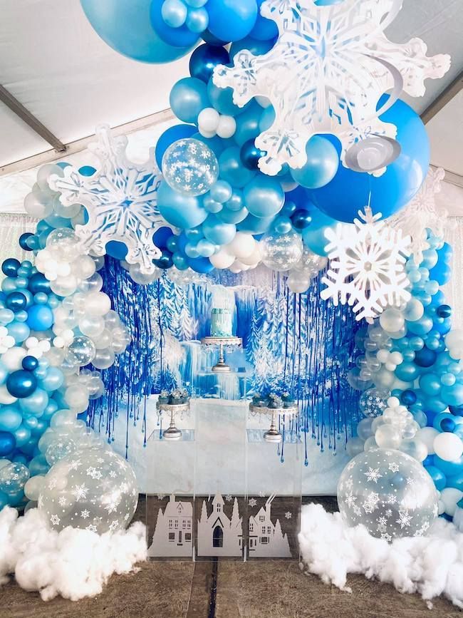 a room filled with balloons and snowflakes