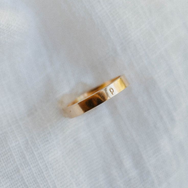 Sleek, minimal, bold. The Infinity Band adds the perfect thickness to any ring stack. Personalize it with an initial! - Made with 14k gold filled or sterling silver material - Rectangle band, 3x1mm thick - Hand-stamped with a san serif lowercase letter (1.5mm) Please note: You may experience a slight color difference in places where the metal has been soldered making every piece truly unique. If you do not see your size, reach out to us by email at info@hellorising.com. We believe that everyone Infinity Band, Lowercase Letter, Ring Stack, The Infinity, Silver Material, Lower Case Letters, Stacking Rings, Gold Bands, Hand Stamped