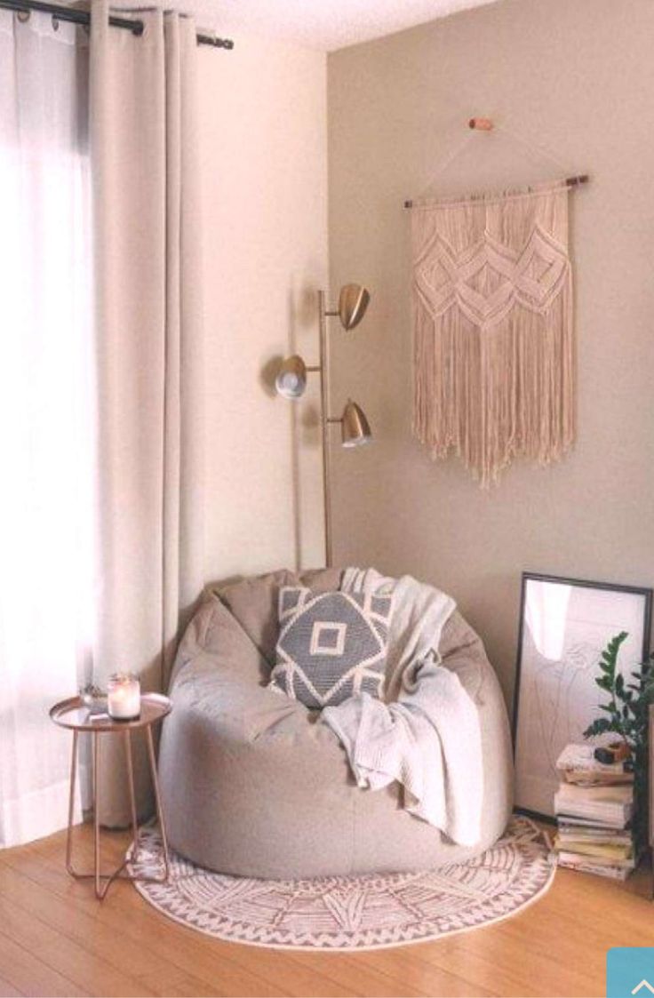 a living room filled with furniture next to a window covered in curtains and fringes