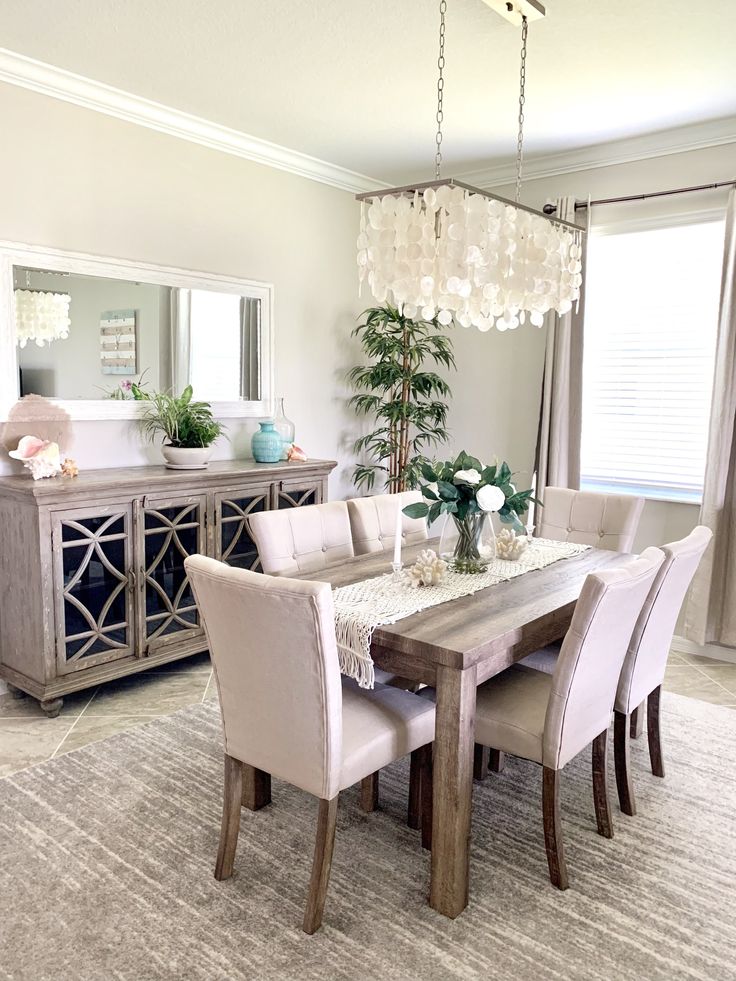 a dining room table with chairs and a chandelier