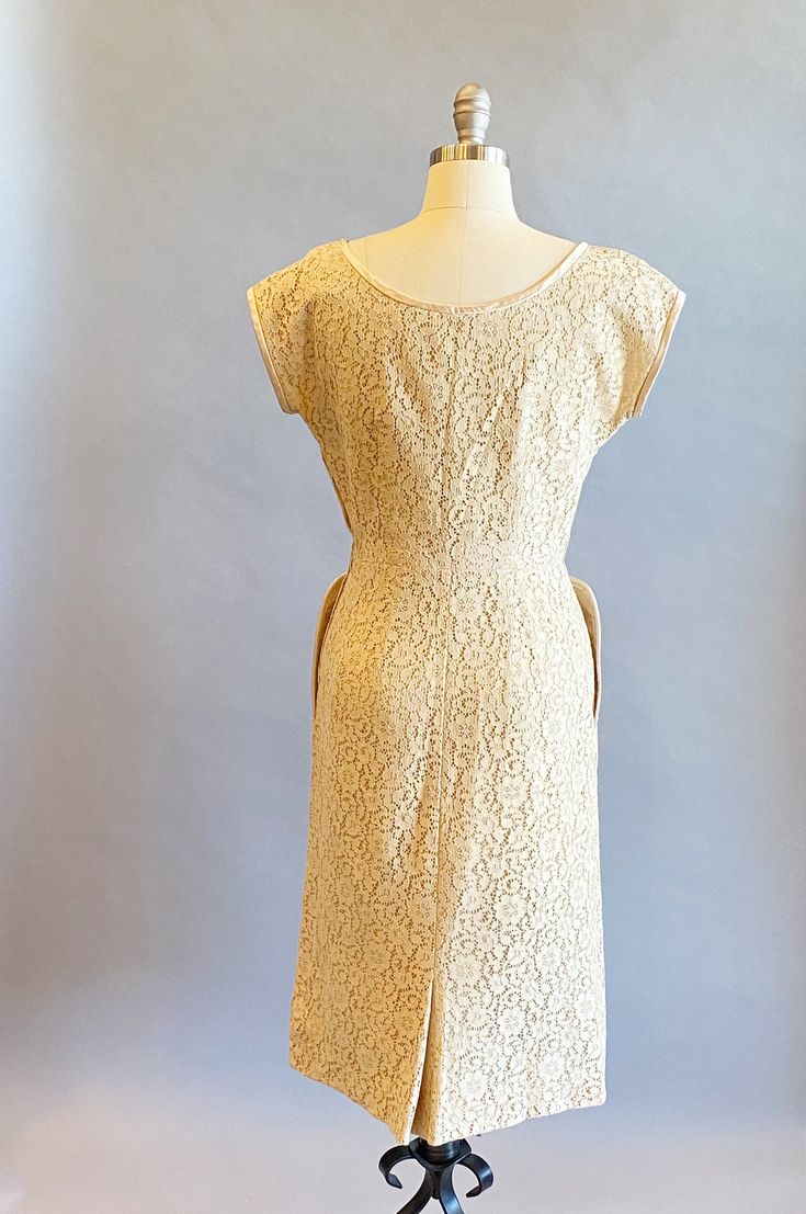 "1950s light beige floral lace party dress. Matching satin trimmed curved neckline that points down into an attached bow and rhinestone detail. Cap sleeves and two large satin trimmed hip pockets. Back center kick pleat on the back of the skirt. Hidden side metal zipper and lined in taffeta. Size- Small Bust - 37\" Waist - 26\" Hips - 40\" Length - 43\" Label: R&K Original Condition: Excellent vintage condition. All vintage is sold in \"as-is\" condition. We do our best to inspect, correct, Beige Dress With Fitted Bodice For Vintage Events, Beige Dresses With Fitted Bodice For Vintage Events, 1950s Style Fitted Cream Vintage Dress, Vintage Dress With Scalloped Lace And Fitted Bodice, Cream Fitted 1950s Style Dress, Fitted Cream Dress In 1950s Style, Cream Fitted Dress In 1950s Style, Fitted Beige Dress For Vintage Events, Retro Beige Dresses For Vintage Events