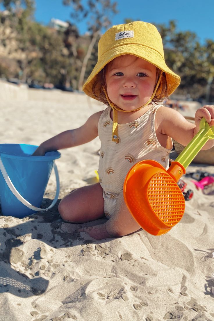 Introducing the Baby Linen Bucket Hat in yellow! Keep your little one protected and stylish with this washable, beach-ready accessory. Made for sunshine lovers, this sun hat is just the ticket for fun in the sun. Don't miss out on this must-have summer essential – shop now! Cotton Bucket Sun Hat For The Beach, Cotton Bucket Hat For Beach, Cotton Sun Hat With Uv Protection For Playtime, Wide Brim Bucket Hat With Upf 50+ For Playtime, Summer Cotton Sun Hat For Playtime, Summer Sun Hat With Upf 50+ For Playtime, Summer Cotton Bucket Hat For Playtime, Adjustable Summer Bucket Hat For Playtime, Playful Sun Hat With Upf 50+ For Beach