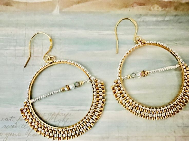 Beaded hoop earrings with Swarovski crystal accents. Hand beaded with 24K gold plated delica beads and silver plated beads. A gorgeous gift for someone special, or for yourself! Gold Beaded Earrings With Spacer Beads, Gold Hoop Earrings With Tiny Beads, Hoop Jewelry With Gold Beads, Gold Small Hoop Earrings With Spacer Beads, Gold Beaded Metal Hoop Jewelry, Gold Beads Small Hoop For Jewelry Making, Gold Beads Hoop Jewelry, Gold Small Hoop Earrings With Tiny Beads, Gold Hoop Jewelry With Tiny Beads