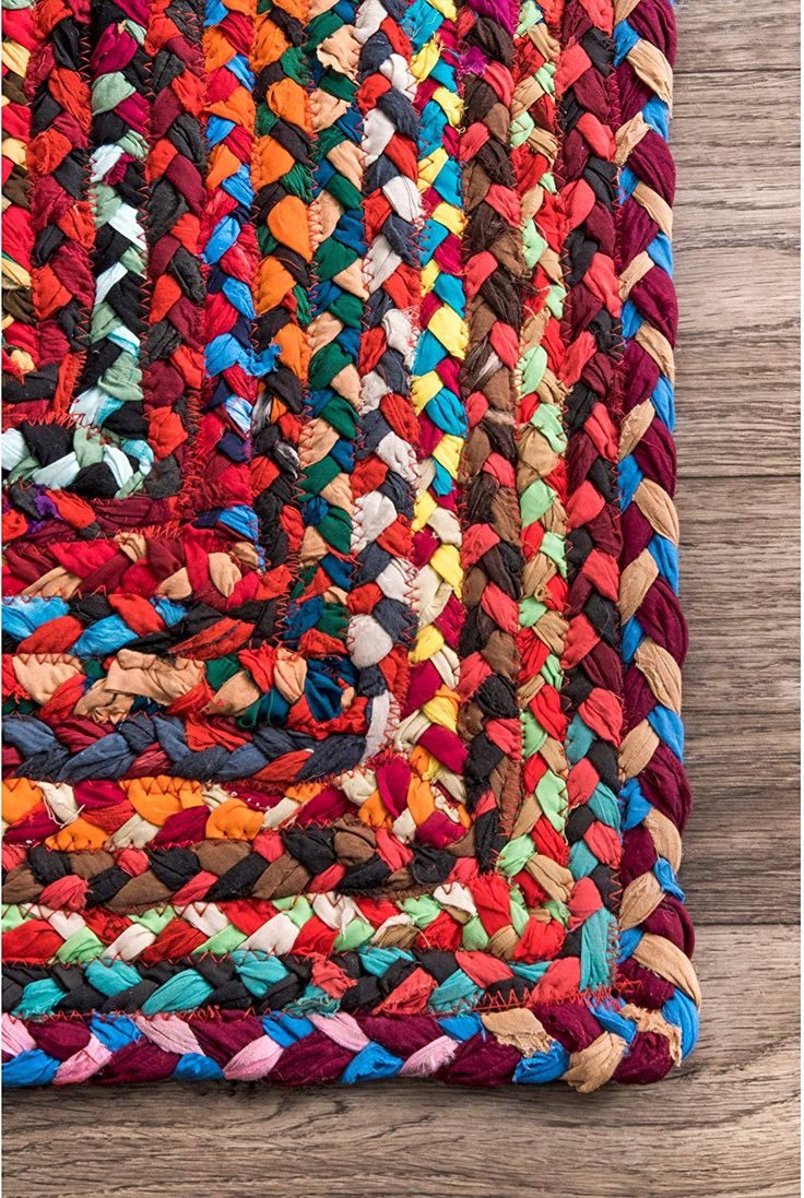 multicolored braided rug on wooden floor