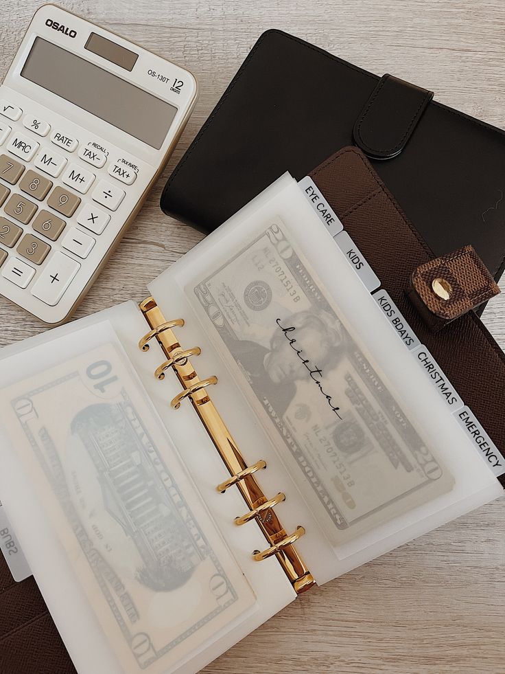 a note book, pen and calculator on a table