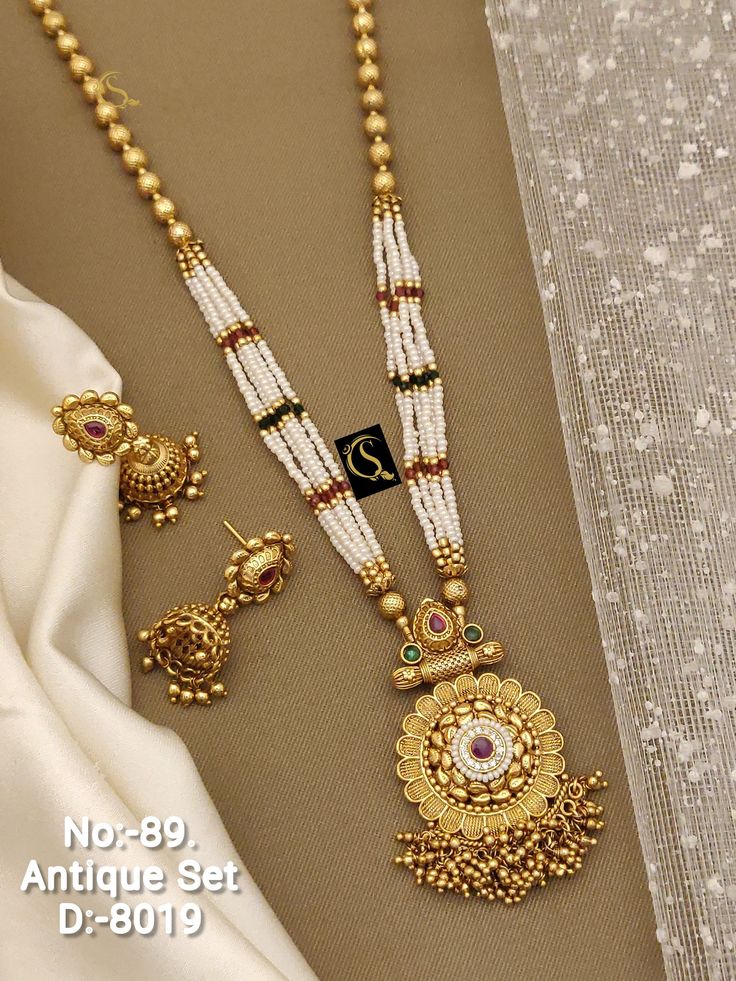 Description :- South Indian Necklace Set Bollywood Necklace Earring Set Ethnic Gold Plated Indian Wedding Jewelry Party Wear Necklace Set Gift yourself a royal look with this perfectly crafted necklace set from Manalisstudio. Crafted with high quality CZ stones, it is impressive in design. The green enamel artwork adds perfect texture to the design. Perfect for weddings and festivities, this antique necklace set should be put on with your favorite sari or lehenga. 100% Satisfaction. Long Lasting South Indian Necklace, Bollywood Necklace, Indian Necklace Set, Indian Necklace, Rainbow Wallpaper, Gold Fashion Necklace, Wear Necklaces, Indian Wedding Jewelry, Antique Necklace