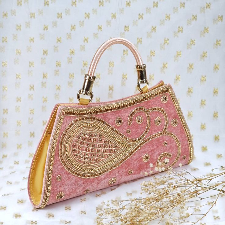 Rumana Luxury Zardosi Embroidered with Hand crafted hand Purse with handle.  Perfect for evening parties and a special ocassion.  We try to take pictures as normal as we can but colors may slightly vary due to different lighting setups. Please note: No Returns No Exchange. But If you have any issue with your order, Kindly contact us before leaving a review Elegant Pink Shoulder Bag For Festivals, Elegant Pink Shoulder Bag For Festive Occasions, Traditional Pink Shoulder Bag For Evening, Pink Shoulder Bag With Handwork For Party, Pink Bags For Evening And Festivals, Elegant Pink Embroidered Fabric With Mirror Work, Bollywood Style Embellished Bags For Wedding, Bollywood Style Bags With Handwork For Reception, Pink Embroidered Clutch Bag