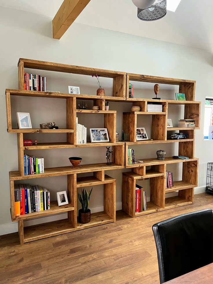 a wooden book shelf filled with books on top of a hard wood floor