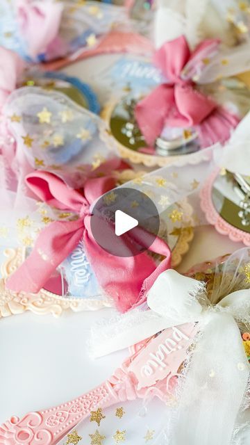 some pink and gold hair clips on top of a white table with other items in the background