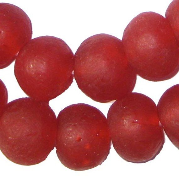 some red balls are on a white surface