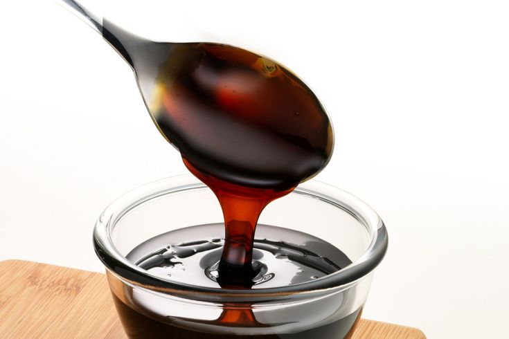 a spoon full of liquid being poured into a bowl