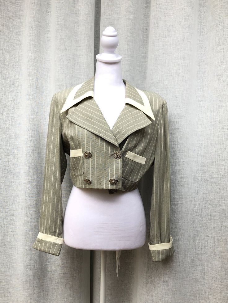 Very beautiful evening striped cropped gray and ivory blazer/jacket by farouche by Lori Weidner with padded shoulders, two patch pockets and beautiful metal tone floral buttons, double breasted.  Size marked 6. Great vintage condition, one very small mark on one of the pockets, please see pictures. Measurements (flat) Shoulder to shoulder: 16" Armpit to armpit approx: 19" Shoulder to hem length approx: 15" Sleeve length: 22" EB2 Bolero Blazer, Ivory Blazer, Jupiter Fl, Idea Board, Beautiful Evening, Double Breasted, Blazer Jacket, Art Collection, Bathing Beauties