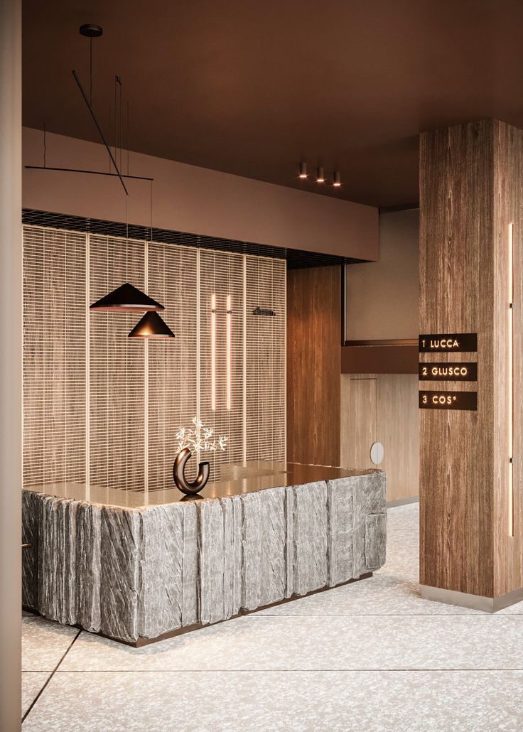 an office lobby with marble counter tops and wooden partitions