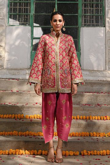 A fresh spin on a classic silhouette - a coral printed khaddi silk jacket with gota and zardoze work and colourful tassel details. The look is completed with a coral raw silk shalwar embellished with embroidered floral motifs. Designer Cotton Silk Bandhgala For Festivals, Bollywood Style Designer Cotton Silk Bandhgala, Designer Cotton Silk Bandhgala With Dupatta, Festival Cotton Silk Bandhgala With Gota Work, Anarkali Bandhgala With Gota Work For Festive Season, Cotton Silk Bandhgala For Navratri Festive, Navratri Festive Cotton Silk Bandhgala, Festive Cotton Silk Bandhgala For Navratri, Eid Cotton Silk Nehru Jacket With Gota Work