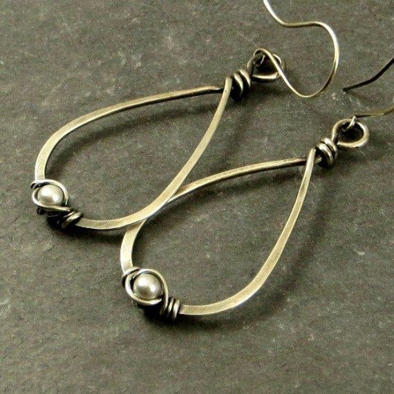 Eco friendly sterling silver (16G) has been hand formed and hammered into teardrops. An organic spiral has been wire wrapped around a 4mm cream Swarovski pearl. The teardrops have been oxidized and lightly brushed with steel wool and then polished for a soft patina. Ear wires are hand formed from sterling silver. Earrings measure 2.75 inches from top of ear wire to bottom of teardrop. All silver used has come from a recycled source. All pieces come in a craft box wrapped in a ribbon that is tied Classic Metal Teardrop Pierced Earrings, Elegant Metal Teardrop Earrings With Wire Wrapped Detail, Elegant Metal Teardrop Earrings Wire Wrapped, Classic Handmade Teardrop Hoop Earrings, Elegant Metal Wire Wrapped Teardrop Earrings, Handmade Teardrop Metal Pearl Earrings, Silver Metal Teardrop Earrings Wire Wrapped, Teardrop Pearl Earrings With Metal Ear Wire, Silver Metal Wire Wrapped Teardrop Earrings