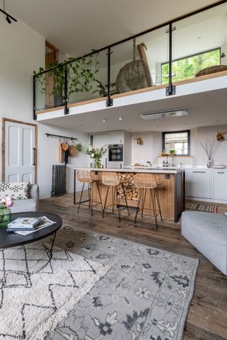 a living room filled with furniture and lots of windows