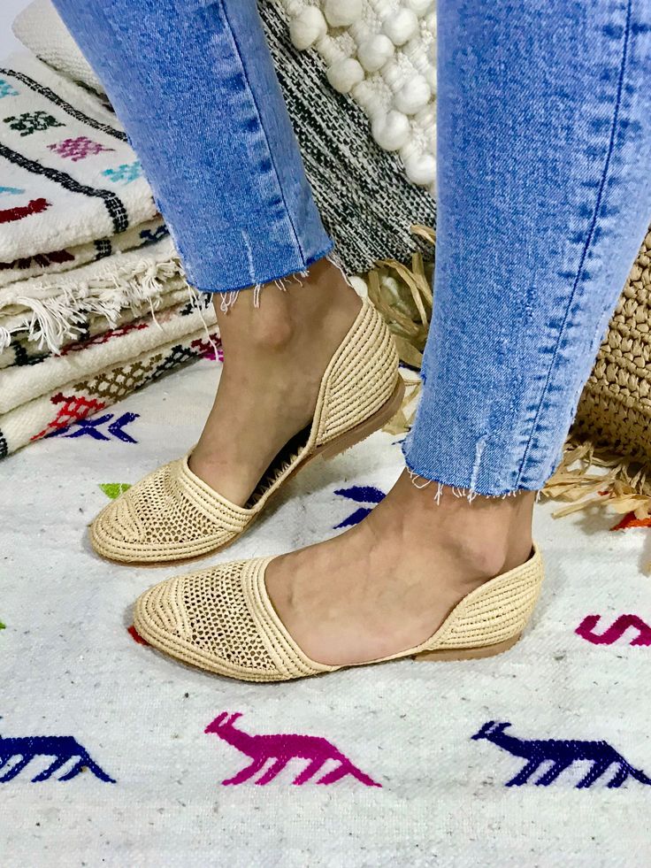 We fell in love with these lightweight shoes and now we want to share this love with you! The slippers are handcrafted in Morocco following old traditions. It takes one day to finish one pair of shoes: That's slow fashion! The upper material is made from palm leaves (raffia) and the sole is a structured rubber. The design is unique and furthermore super comfortable. We don't wanna take them off anymore. This style has additionally a closed heel part to give more stability. Made in Morocco. When Beige Flat Slip-ons With Woven Sole, Beige Slip-ons With Woven Sole, Beige Closed Toe Flats With Textured Footbed, Closed Toe Slippers For Spring, Beige Slip-on Flats With Textured Footbed, Beige Textured Slip-on Flats, Summer Pointed Toe Slippers With Leather Sole, Beige Closed Toe Slip-ons With Rubber Sole, Beige Closed Toe Flats With Woven Sole