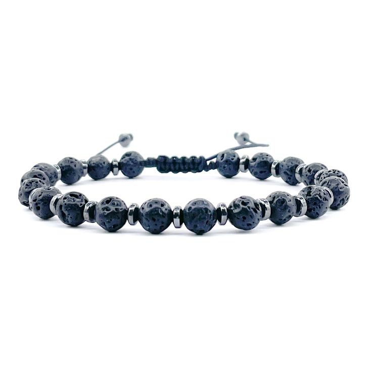 This elegant men's bracelet is made with Black Lava stones measuring 6mm, separated from each other by tiny 5mm Rondelle stone hematite separators, and strung on a black waxed thread made of 100% polyester.  It measures 6.5 inches or 16.5 cm. The closure is adjustable and can thus accommodate thicker wrists. If you believe it needs to be significantly larger or smaller, please let me know the wrist size and I will be happy to customize it for your order.  The standard size is ready to ship in 1-2 days. Custom pieces can take 3-4 business days to be shipped.  This is a special present for a special person. Because Lava stones are made from molten lava that has solidified under intense heat and pressure, they are known for symbolizing strength and courage. Paired with the Hematite stones, wh Adjustable Black Wristband With Gemstone Beads, Adjustable Hand-strung Lava Stone Bracelet, Adjustable 8mm Lava Stone Beaded Bracelets, Black Lava Stone Beaded Bracelets, Hand-strung, Hand-strung Black Lava Stone Beaded Bracelets, Black Hand-strung Lava Stone Beaded Bracelets, Adjustable Black Wristband With 8mm Beads, Adjustable Lava Stone Bracelets With Gemstone Beads, Adjustable Lava Stone Bracelet With Gemstone Beads