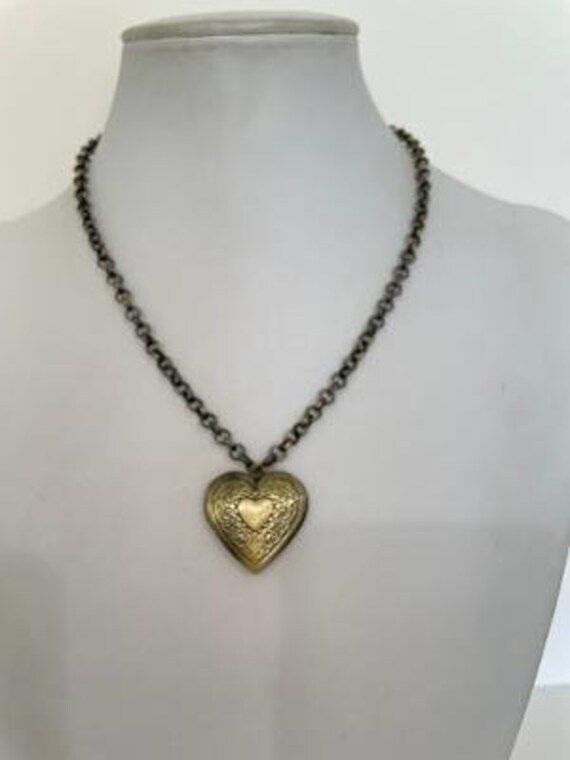 Etched Bronze Heart, one inch in diameter and length, on antiqued Rollo. The necklace is 17" in length.  Can dress up or down its use. Antique Gold Heart Pendant Vintage Necklace, Vintage Antique Gold Heart Pendant Necklace, Vintage Bronze Heart Pendant Necklace, Antique Gold Heart Necklace With Vintage Charm, Vintage Bronze Necklaces For Valentine's Day, Vintage Bronze Necklace For Valentine's Day, Vintage Heart Necklace With Antique Finish, Vintage Bronze Heart Necklace, Vintage Metal Heart Necklace