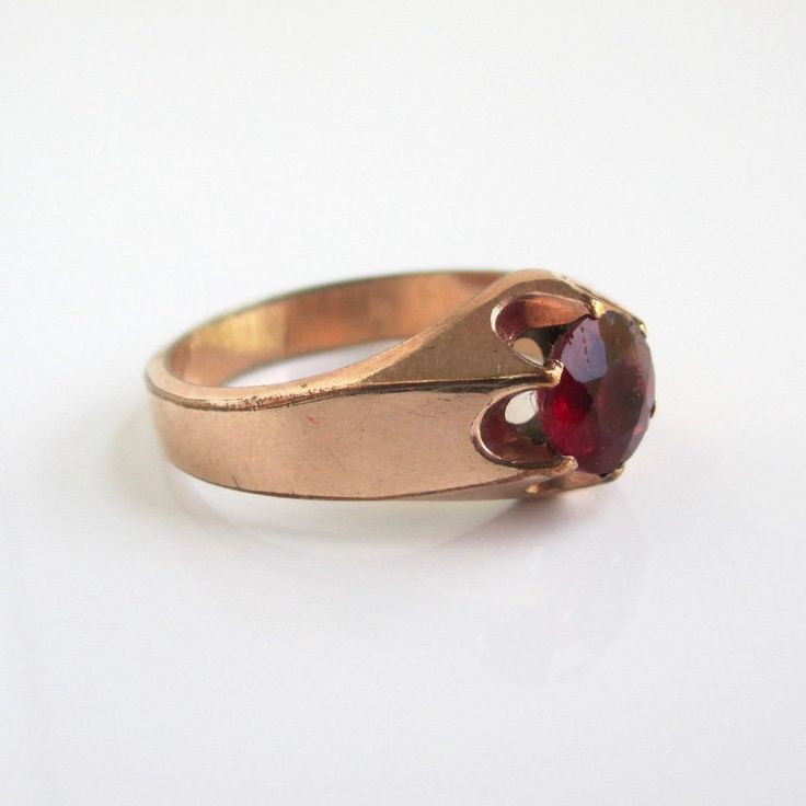 A vintage / antique ring in gold filled or gold shell with prong set faceted red center stone (stone shows wear and scratches).  A size 10 on my ring sizer (I would consider it unisex).  Marked "KMJ Co".  Solid weight at 4.4 grams.  I haven't polished or done anything to it.  Stone is 7mm in diameter. Please check out my store with similar things added almost daily. Remember, shipping for additional items is always free. Antique Red Signet Ring In 14k Gold, Antique Red 14k Gold Signet Ring, Vintage Solitaire Signet Ring, Antique Red Ruby Ring In 14k Gold, Vintage Gold Ruby Birthstone Ring, Vintage Gold Ruby Ring With Birthstone, Gold Ruby Ring Vintage Birthstone, Antique Red Rings With Prong Setting, Antique Red Ring With Prong Setting