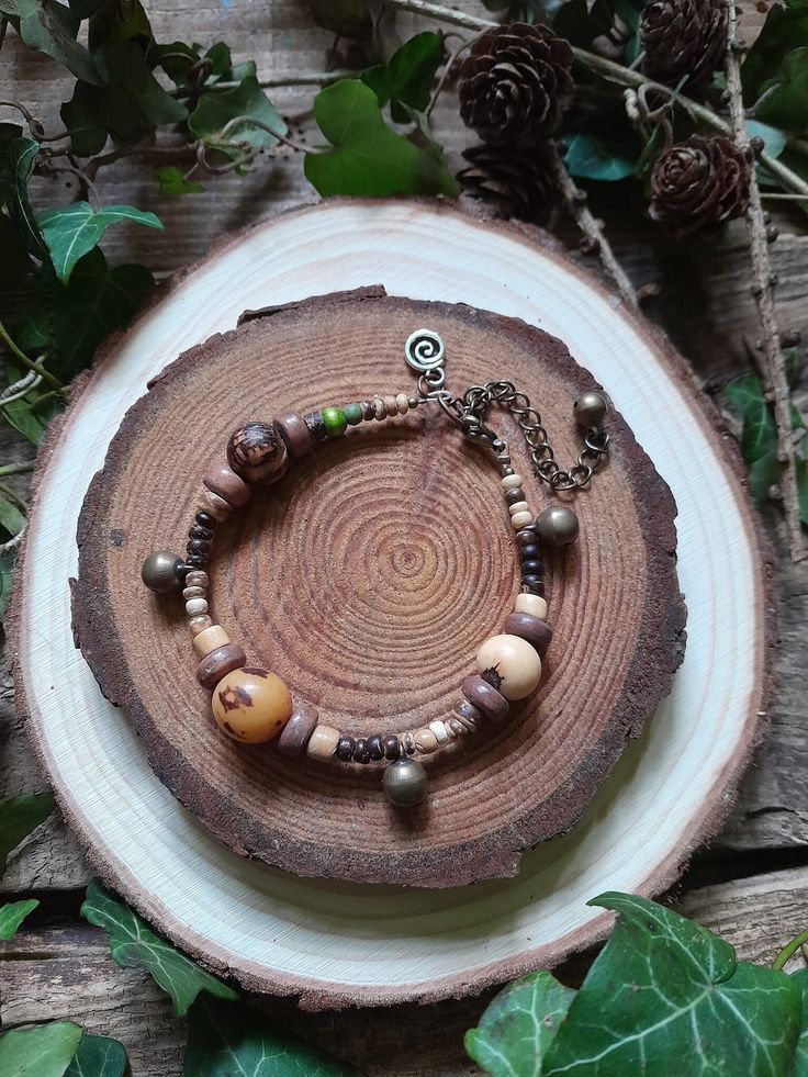 Forest Recycled Beads Bracelet Artisan crafted with recycled natural beads, handcrafted beads, seed pods, and bells. These bracelets measure approximately around 19.5cms around, plus a 7cm extension chain. You will get the exact same bracelet that's in the pictures. * Instagram: https://www.instagram.com/lea_and_elfie/ * Find Lea's page on facebook here: https://www.facebook.com/leawilliamsartstudio/ * www.littlepentre.co.uk * www.facebook.com/TinkerTailor * www.facebook.com/LittlePentreOrganicE Nature-inspired Wooden Beaded Bracelets For Gifts, Nature-inspired Wooden Beaded Bracelets As Gift, Adjustable Nature-inspired Bracelet With Round Beads, Adjustable Beaded Nature-inspired Bracelet, Earthy Wooden Beaded Bracelets As Gift, Nature-inspired Adjustable Beaded Bracelet With Round Beads, Earthy Wooden Beaded Bracelets For Gift, Earthy Colorful Beaded Bracelets For Festivals, Earthy Style Colorful Beaded Bracelets For Festivals