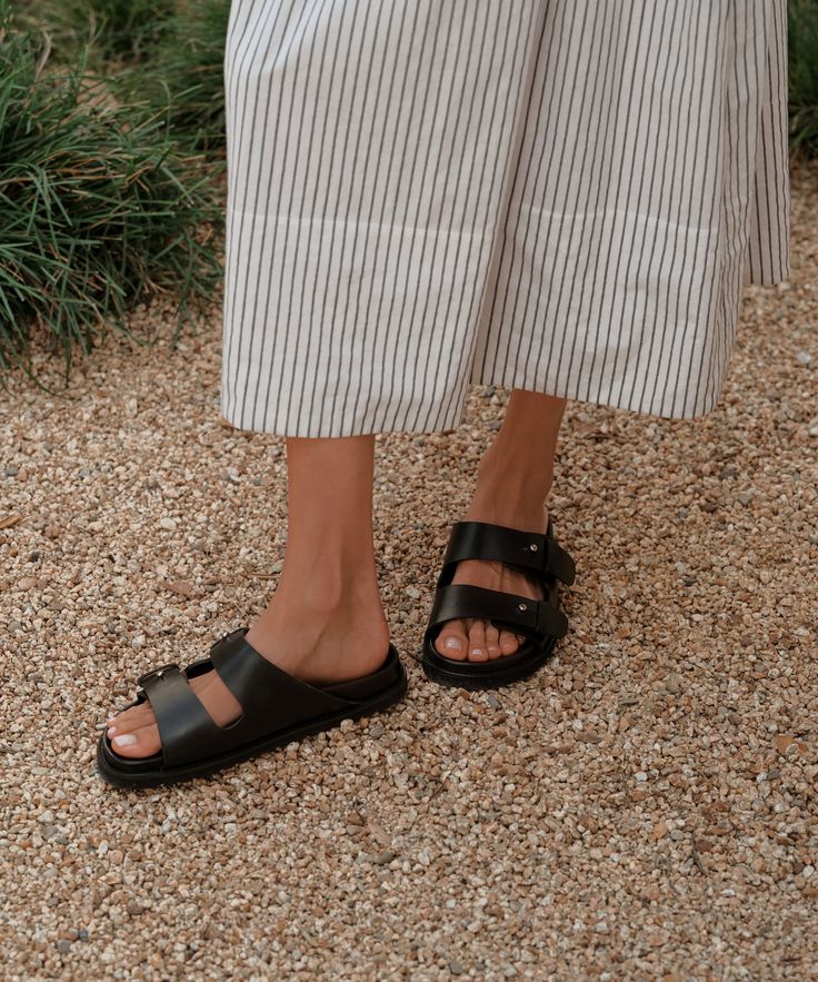 Hutton Slide Sandal Black Laid-back and made to last a lifetime, the Hutton Slide Sandal is the definition of an everyday staple shoe. Featuring classic vegetable-tanned cowhide leather and our signature push-button detailing, they pair perfectly with everything from vintage denim to simple slip dresses. Leather upper with molded leather footbed. Made in Portugal. | Jenni Kayne Women's Hutton Slide Sandal Size 39 Classic Calf Leather Sandals For Work, Classic Everyday Sandals With Leather Footbed, Classic Sandals With Leather Footbed, Classic Sandals With Leather Footbed For Everyday, Classic Leather Footbed Sandals For Everyday, Classic Leather Sandals For Everyday, Classic Leather Sandals For Work, Classic Closed Toe Everyday Sandals, Classic Closed Toe Sandals For Everyday