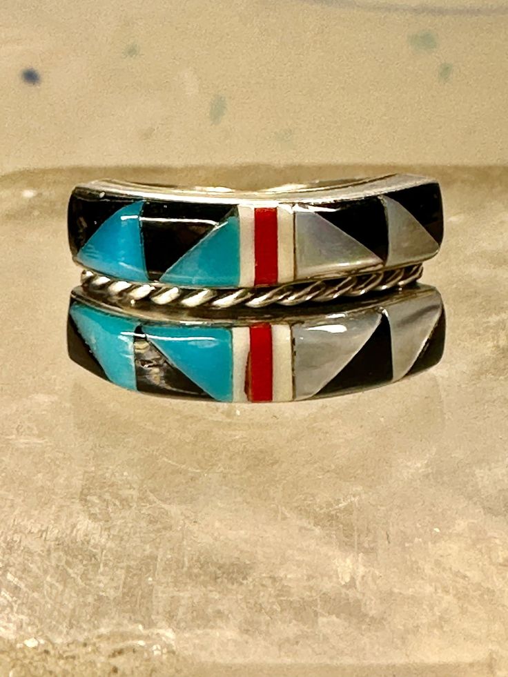 Turquoise ring Zuni band Coral southwest size 5.75 sterling silver girls women  Signed Q.T. Size 5.75 Between a size 5.75 and a size 6 Weight  3.8g Width  3/8" Thinnest part od band in back  3/16" Free Shipping & Free Postal Insurance  Delivered in a Gift Box  Free First Class shipping and postal insurance is included. If you want to upgrade to priority kindly pay an additional fee to do so.  This is recommended if you would like to have your package delivered faster than first class which has s Southwestern Multi-stone Jewelry For Anniversary, Southwestern Gemstone Rings For Collectors, Southwestern Multi-stone Rings For Anniversary, Southwestern Style Rings With Inlay, Southwestern Round Rings With Inlay, Southwestern Adjustable Multi-stone Jewelry, Multicolor Gemstone Southwestern Rings, Southwestern Style Multicolor Gemstone Rings, Southwestern Multicolor Turquoise Ring