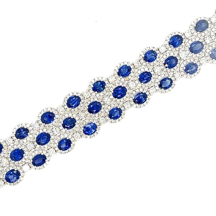 The Sapphire and Diamond Bracelet exudes an air of regal elegance, combining the rich allure of sapphires with the dazzling brilliance of diamonds, all set within an 18KT white gold frame. Wearing this bracelet is akin to wearing a work of art. 54 Sapphires - 23.79CT 54 Round Diamonds - 3.18CT 756 Round Diamonds - 5.64CT 18KT White Gold Luxury Sapphire Bracelets, Luxury Round Sapphire Bracelet, Luxury Sapphire Bracelet, Luxury Sapphire Diamond Round Bracelet, Luxury White Gold Sapphire Diamond Bracelet, Luxury Sapphire Diamond Bracelet, Luxury Sapphire Diamond Bracelet For Formal Events, Luxury Sapphire Diamond Bracelet For Formal Occasions, Luxury Sapphire Tennis Bracelet With Diamond Accents